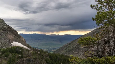 Rain clouds at sunset framed by mountains Video stock 167123903