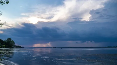Rain clouds. Thunderclouds roll over the river Stock Footage 136117442