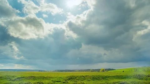 Rain clouds at wild field at spring. Time lapse Video stock 74901246