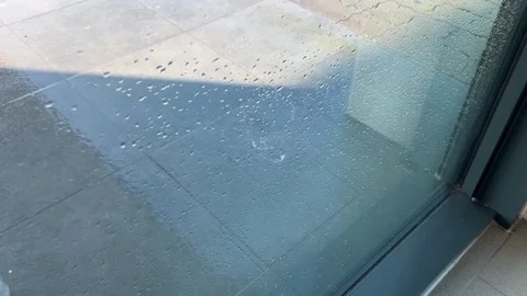 Rain Covered Glass Panel and Wet Pavement Video stock 342606667
