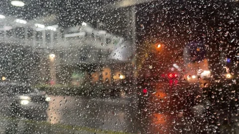 Rain-covered window with city lights glowing in the background. Stock Footage 333937746