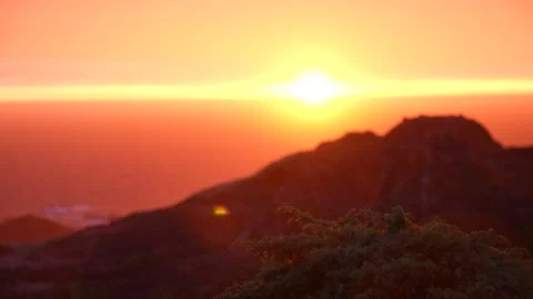 Rain at dawn on the coast with sun in the background Stock Footage 297792386