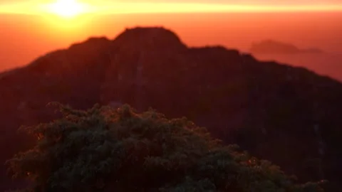 Rain at dawn on the coast with sun in the background Stock Footage 297792387