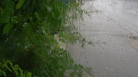 Rain days, heavy rain falling on window surface Stock Footage 233090057