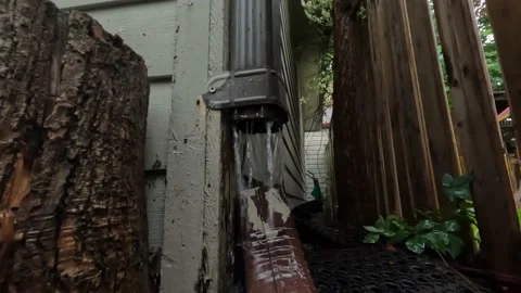 Rain downspout backyard fence low angle Stock Footage 213001691