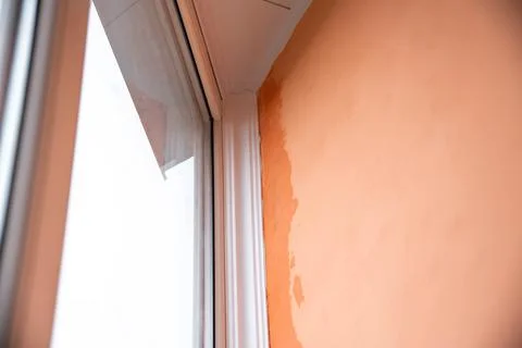 Rain dripping in the corner on the balcony between the window frame and the wall Foto stock