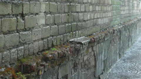 Rain dripping on old ruined wall and basement. close-up side view Stock Footage 310536801