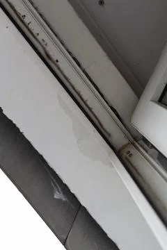 Rain drips between the window frame and the ceiling. Roof damage due to poo.. Stock Photos