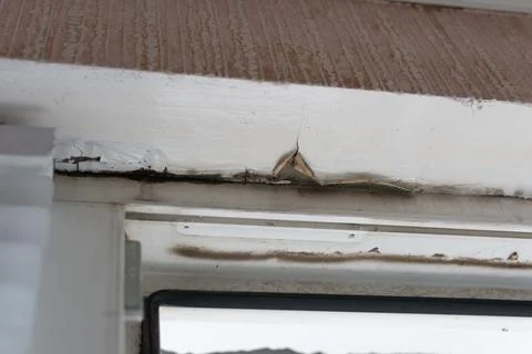 Rain drips between the window frame and the ceiling. Roof damage due to poo.. Stock Photos