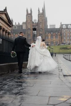 Rain drizzles over stone paths beside grand architecture Fotos Stock