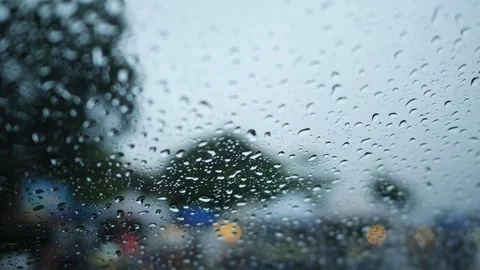 Rain drop on glass window with blur scene of people walking on street market  Stock Footage 99105419