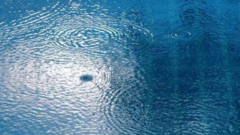 Rain drop on the water pool Stock Photos