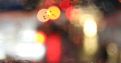 Rain drop on windshield with blur light of vehicle on traffic jam Stock Footage 81259359