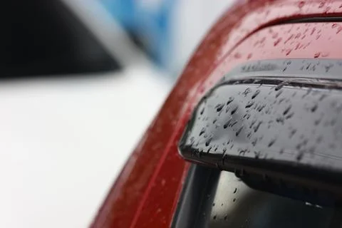 Rain drop on windshield of red car Stock Photos
