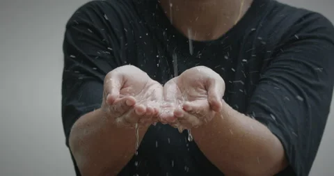 Rain drop into woman's hand in the rainy day. Stock Footage 230085768