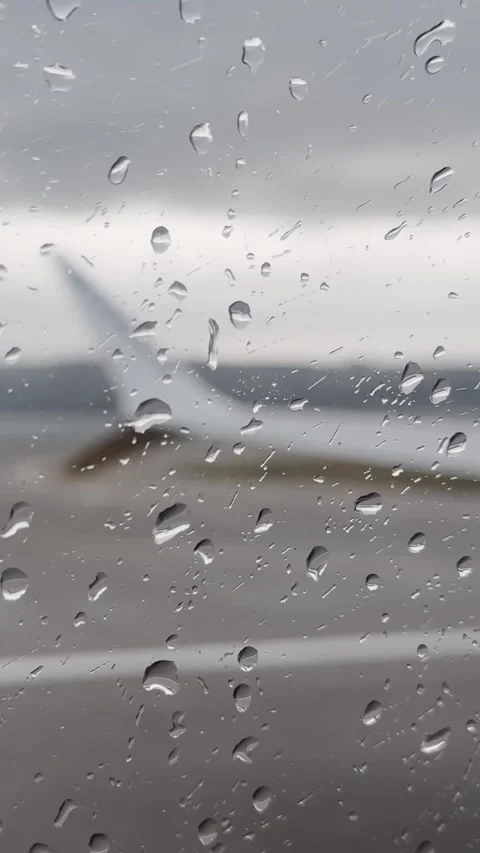Rain droplets on airplane window during delayed departure in Poland, with Stock Footage 337232815