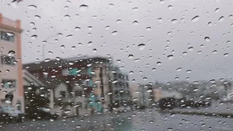Rain droplets on a car windshield, on a cloudy &amp; rainy day Stock Footage 144464379
