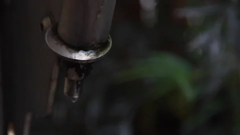 Rain droplets dripping off pipe Stock Footage 148085535