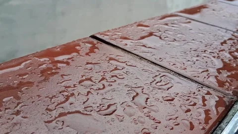 Rain droplets falling on textured red ceramic bricks Stock Footage 346180568