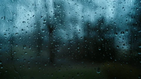 Rain droplets on glass window with blurred background during strong rain. Close Видео 332184882