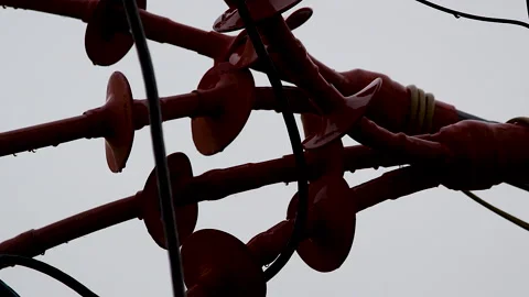 Rain droplets on high voltage power line insulators during monsoon weather Stock Footage 341837561