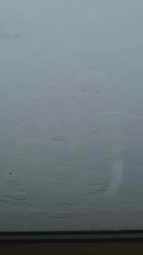 Rain droplets on a house window during a heavy downpour, highlighting protection Stock Footage 281576863