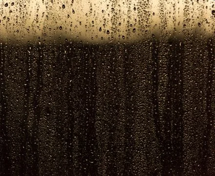 Rain droplets running down a window, abstract backlight background Stock Photos