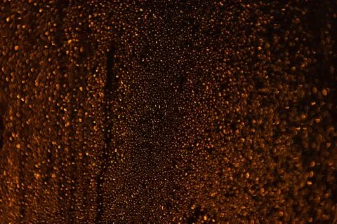 Rain droplets running down a window, abstract backlight background Stock Photos