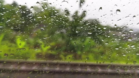 Rain droplets on a train window with a blurred view Stock Footage 326217261