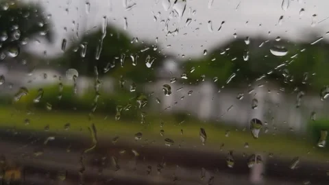 Rain droplets on a train window with a blurred view Stock Footage 326217262