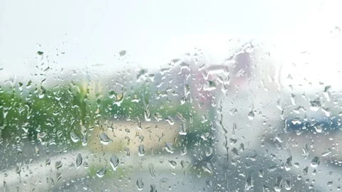 Rain droplets on a wet window. Transparent glass with moisture. Day indoors Stock Footage 141763201
