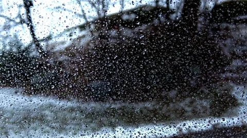 Rain droplets on the window glass Stock Footage 297780418