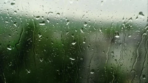 Rain droplets on window glass, highlighting water-repellent properties and abili Stock Footage 276183033