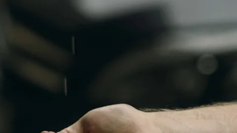 Rain is dropping on a man's hand. It is a first rain in this year. Wet smell of Stock Footage 77583278