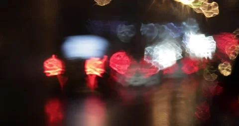 Rain drops 4k falling on a window with bokeh light effects Stock Footage 134215022