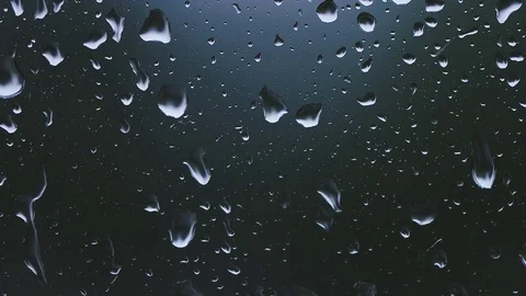Rain drops appearing on a window glass - slow motion Stock Footage 82673064