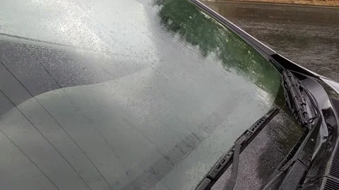 Rain drops are falling on the glass of a car. Stock Footage 143552026
