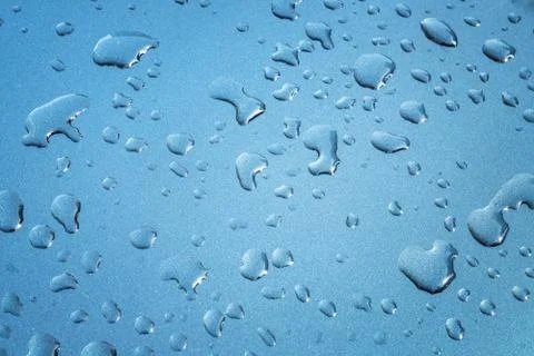 Rain drops are spreaded on a meatllic surface for background Stock Photos