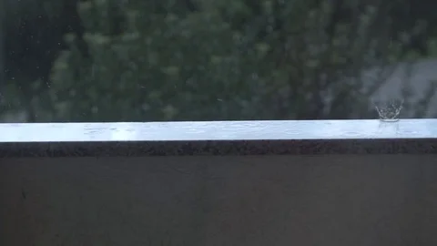Rain drops on balcony in slow motion Stock Footage 80106223