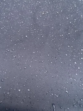 Rain Drops Beading on Water Resistant Dark Navy Textile Macro Stock Photos