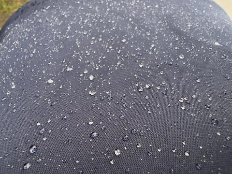 Rain Drops Beading on Water Resistant Dark Navy Textile Macro Stock Photos