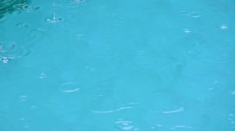 Rain drops in blue water with bubbles Stock Footage 23577100