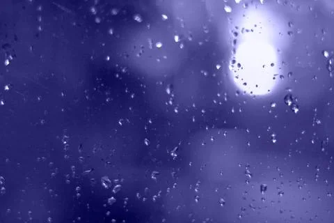 Rain drops with bokeh effect in the night city. Drops of rain on window with  Stock Photos