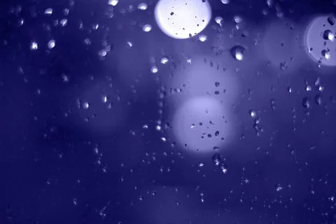 Rain drops with bokeh effect in the night city. Drops of rain on window with  Stock Photos