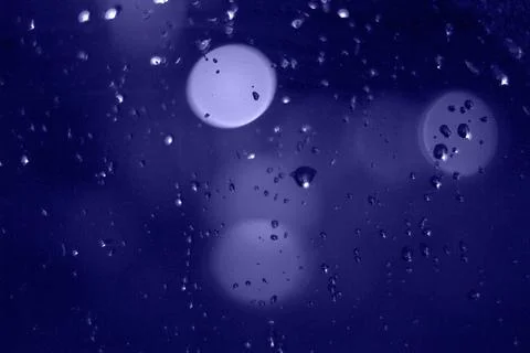 Rain drops with bokeh effect in the night city. Drops of rain on window with  Stock Photos