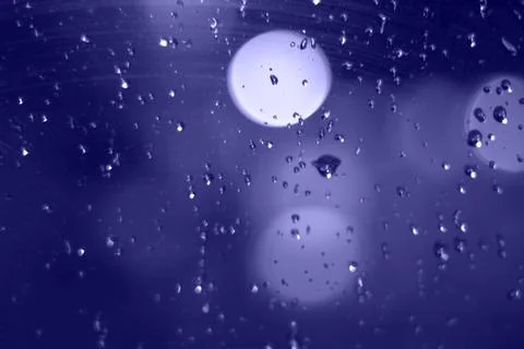 Rain drops with bokeh effect in the night city. Drops of rain on window with  Stock Photos