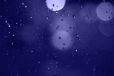 Rain drops with bokeh effect in the night city. Drops of rain on window with  Stock Photos