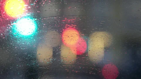 Rain drops on a car window at night. Bright city lights Stock Footage 322814826