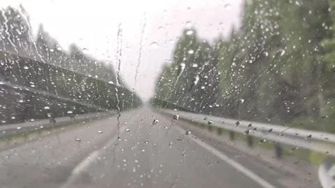Rain drops on car window. on the road Stock Footage 156851587