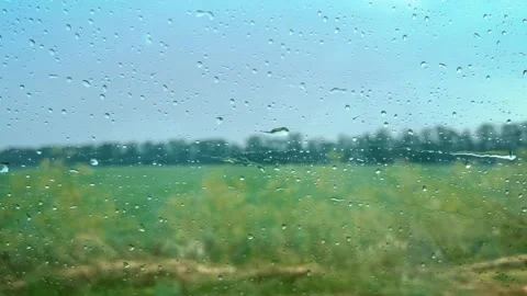 Rain drops on the car window while driving. Video stock 245853899